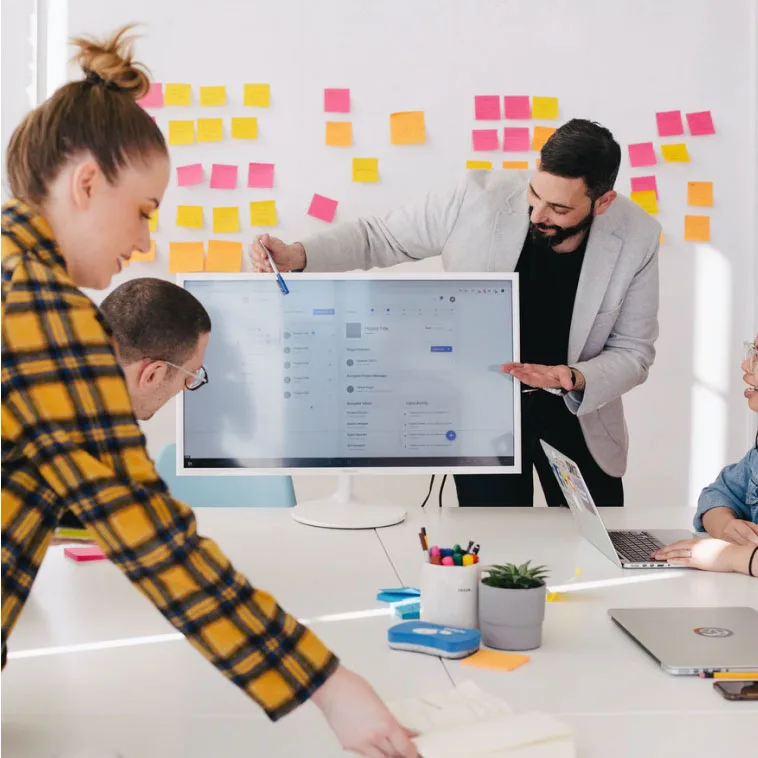 Digital marketing team engaged in strategy planning in a modern office.