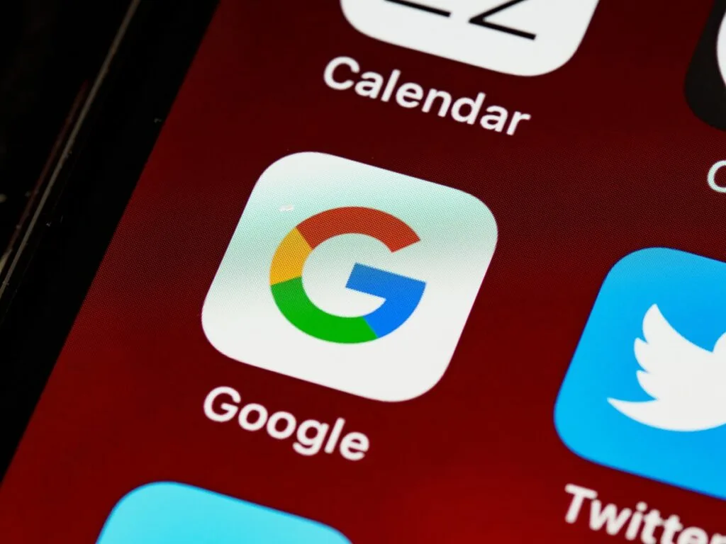 Smartphone displaying the Google app interface on its screen.